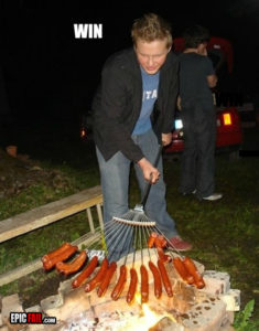 Men cooking sausages
