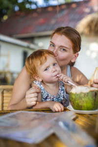 Liza and daughter Nelly enjoying a fresh coconut