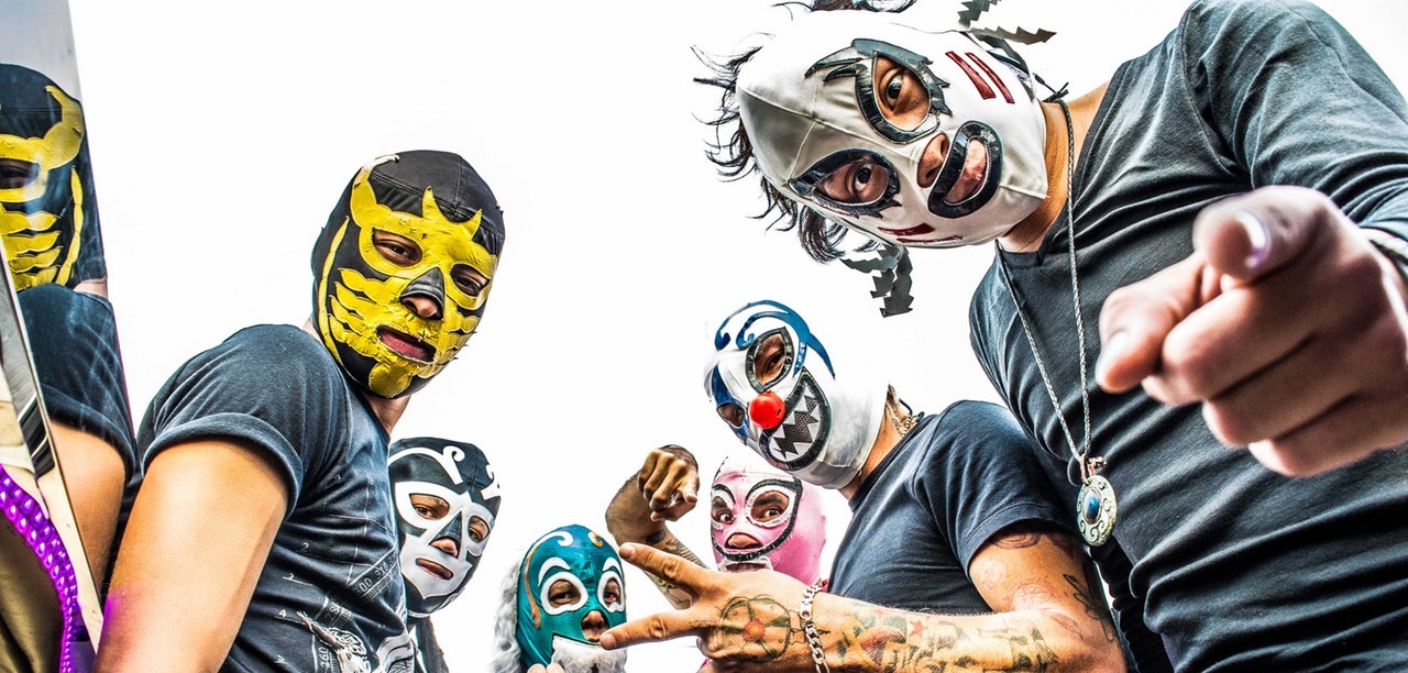 Group of fans wearing Mexican wrestling masks